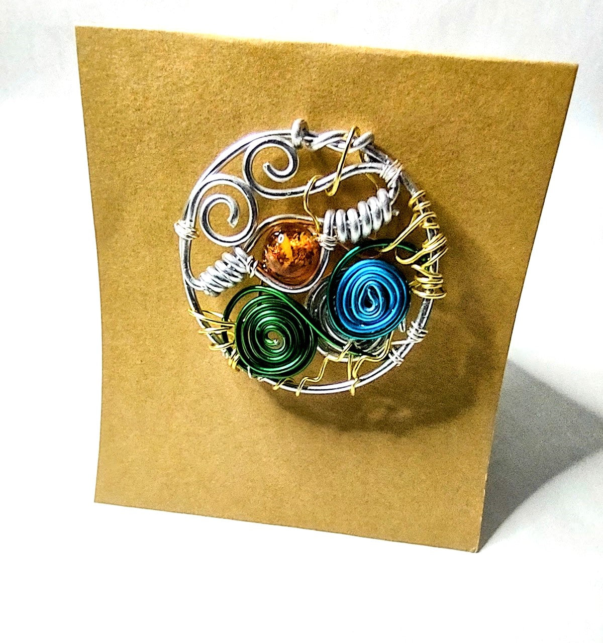 Elegant aluminum wire brooch designed with amber bead and colorful spirals