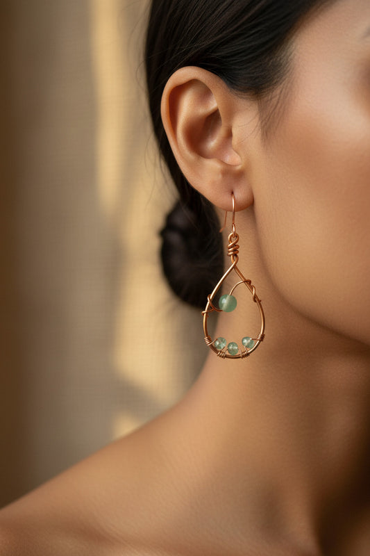 A pair of copper wire wrapped earrings with adventurine beads.
