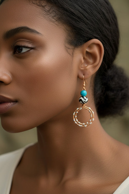 A pair of wire wrapped copper double hoop earrings with bone and larimar agate bead.