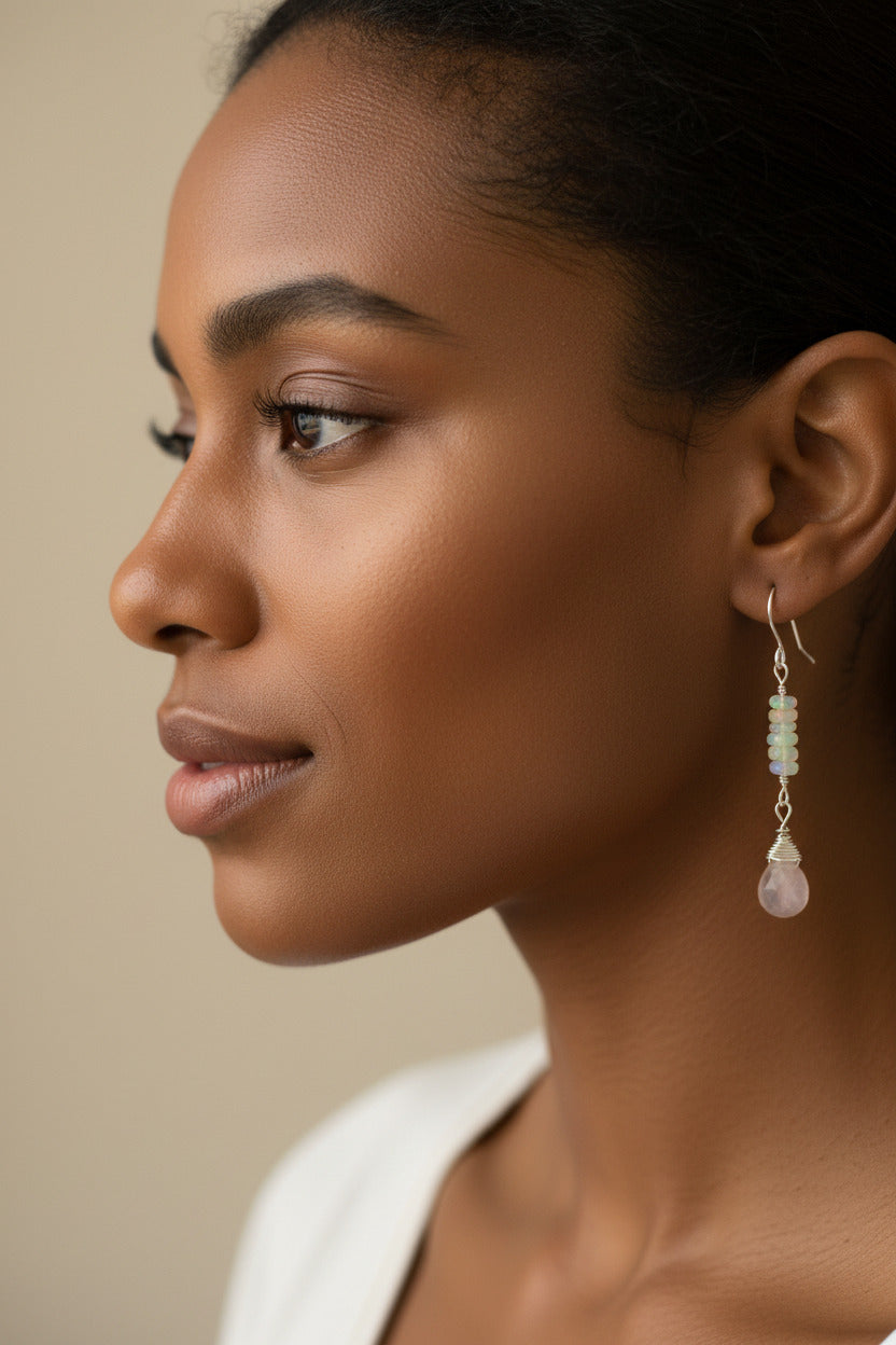 A pair of earrings with opal beads and rose quartz briolette