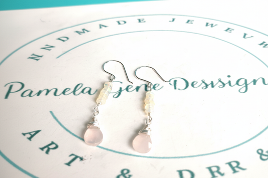 Close up of handmade wire wrapped opal and rose quartz earrings showing detail