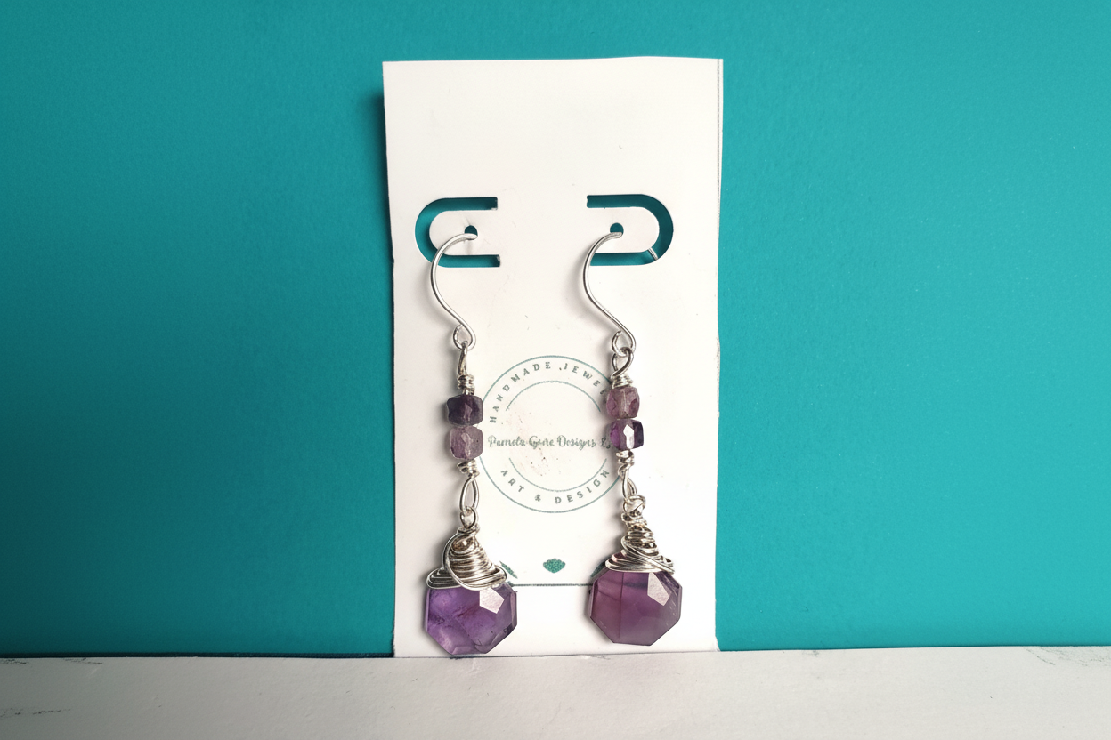 Close up of handmade amethyst briolette earrings with wire wrapped sterling silver
